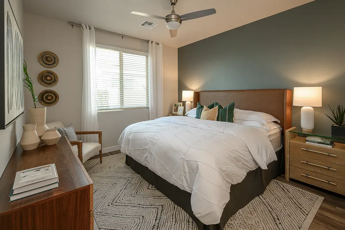 Furnished bedroom shown — representative home at Village at Camelback Park.