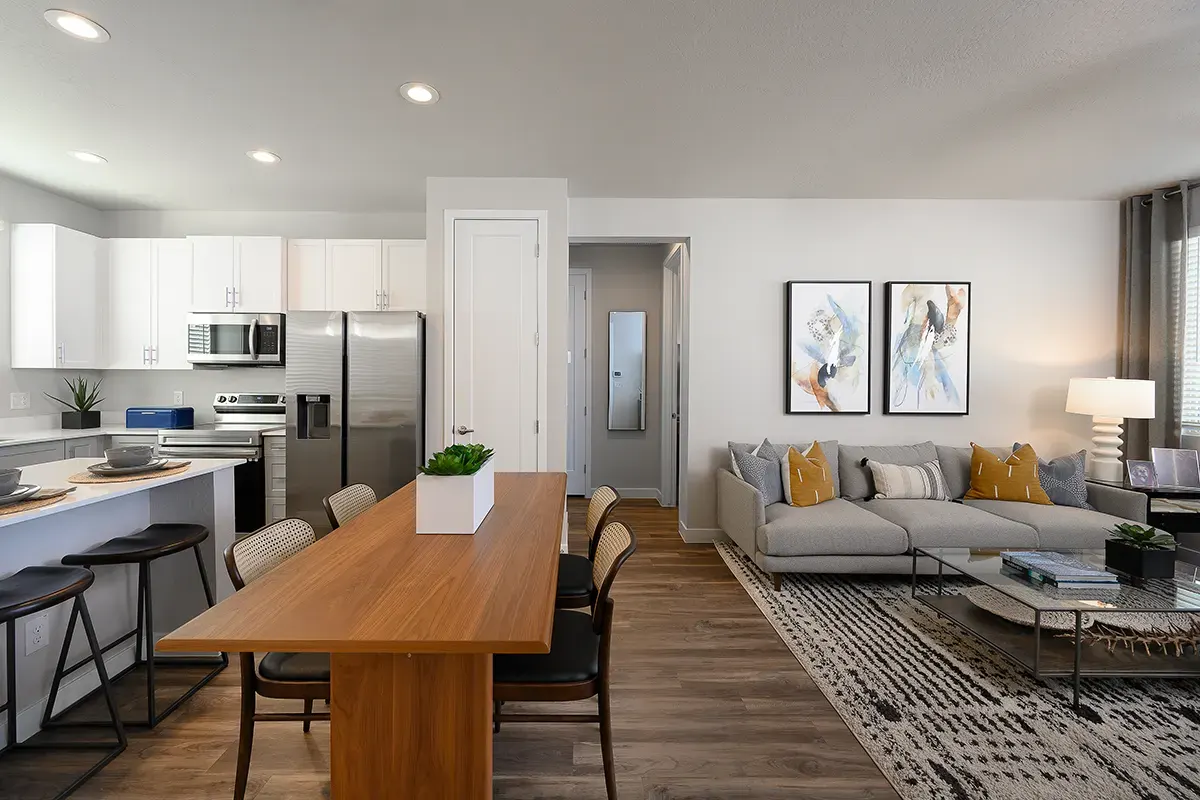 Furnished apartment living area shown — representative home at Village at Camelback Park.