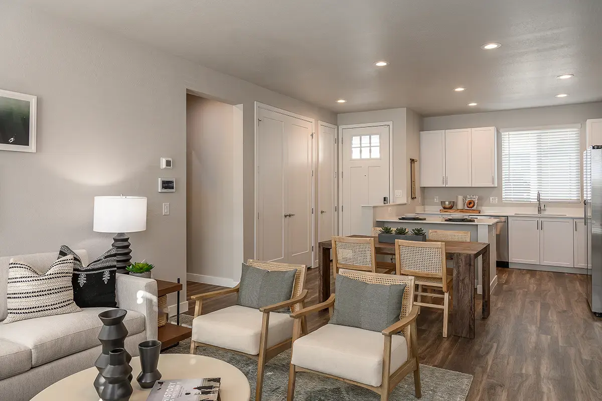 Furnished apartment living area shown — representative home at Village at Camelback Park.