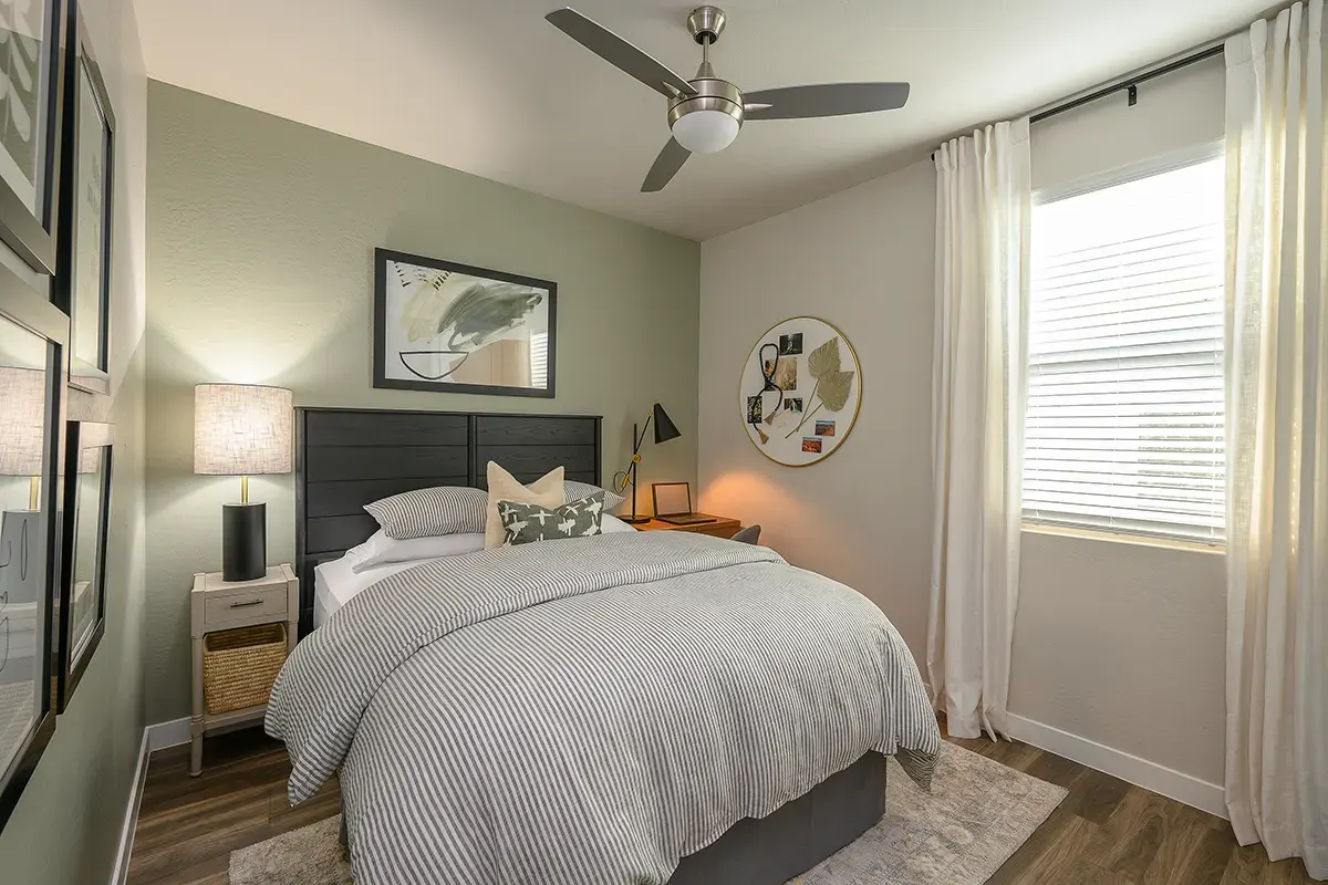 Furnished bedroom shown — representative home at Village at Camelback Park.