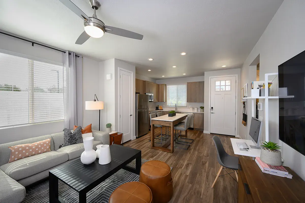 Furnished apartment living area shown — representative home at Village at Camelback Park.