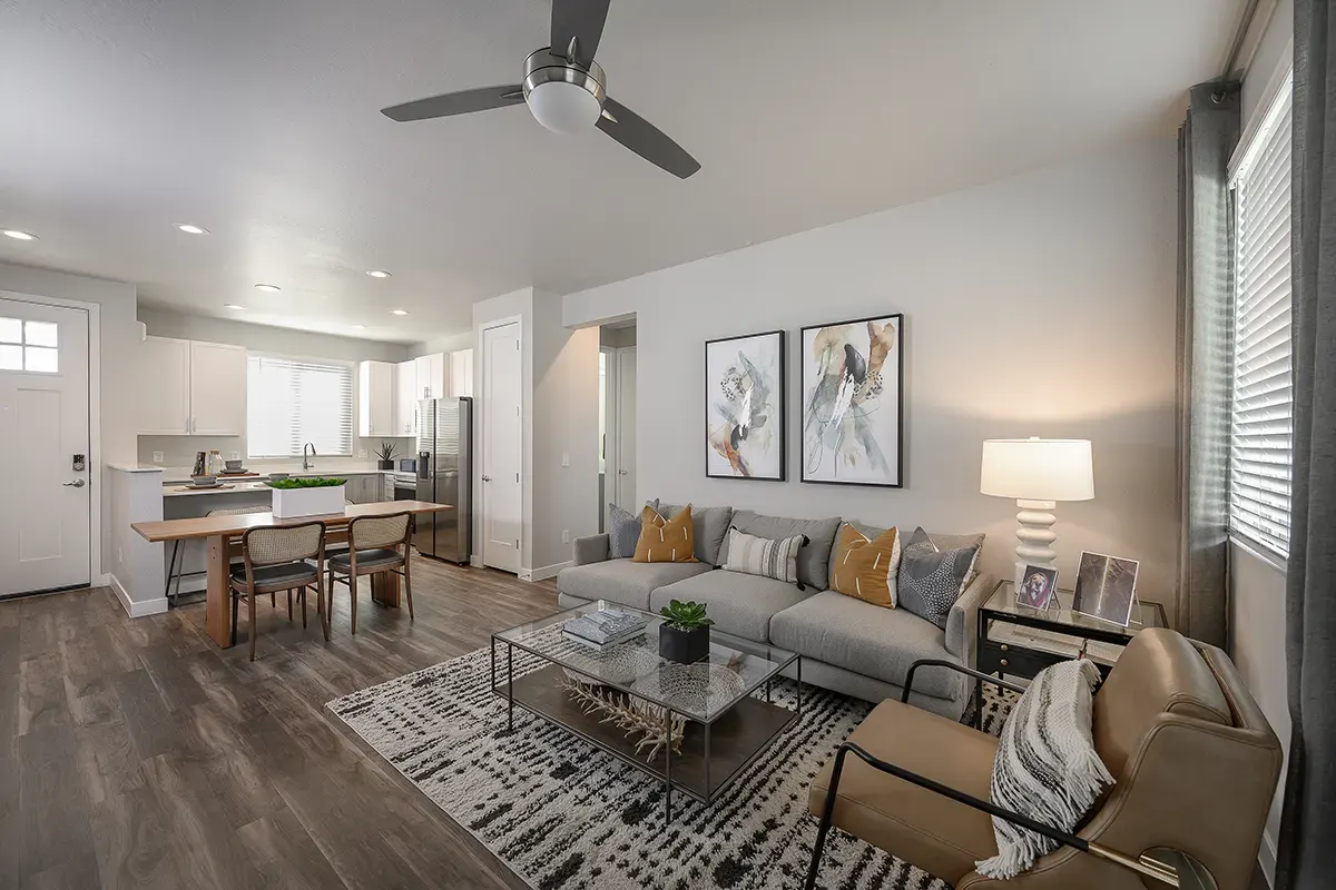 Furnished apartment living area shown — representative home at Village at Camelback Park.