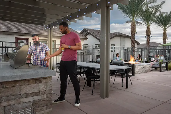 Men BBQing - ladies around fireadults around fire